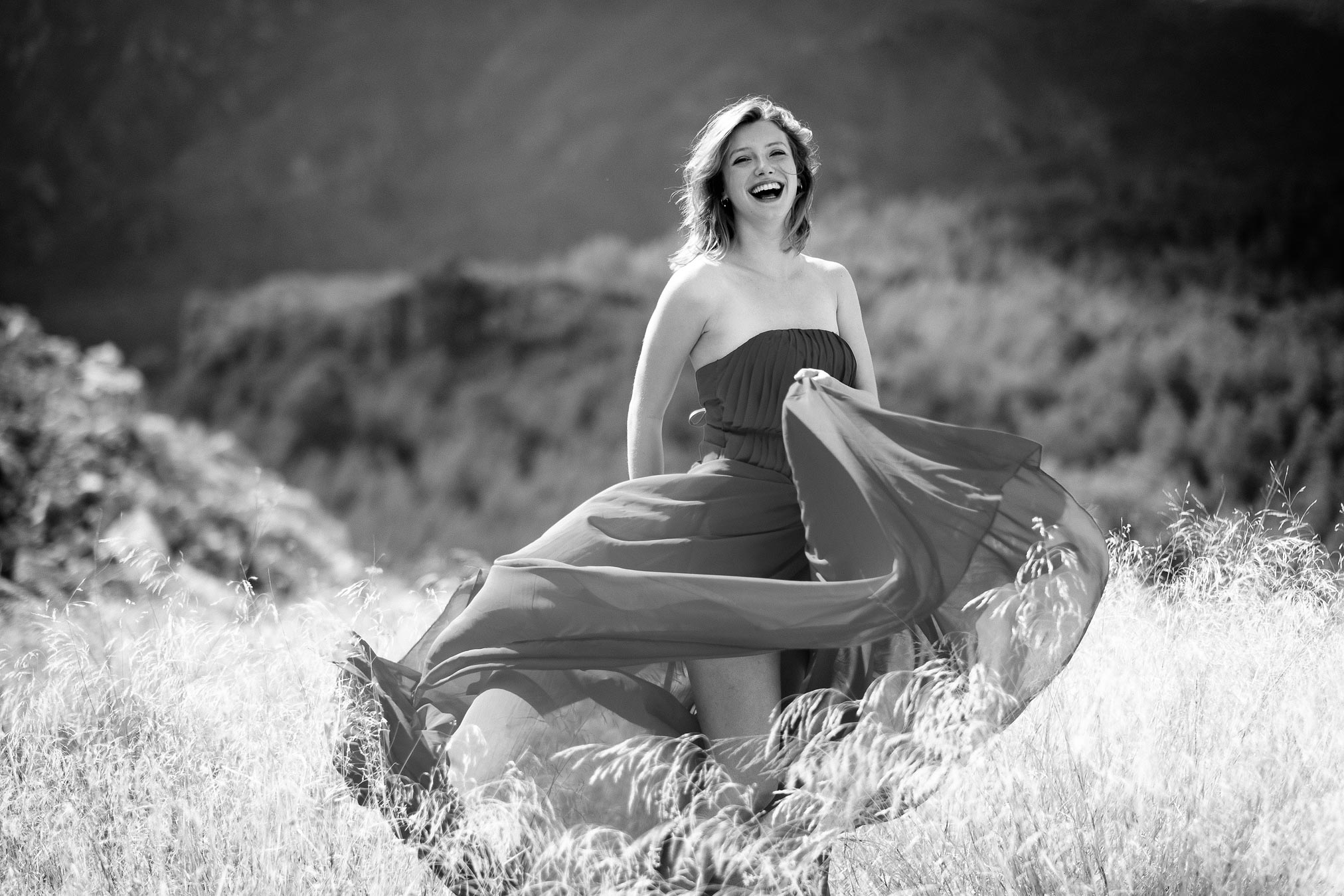Claire Rammelkamp wafting a dress in long grass in Spain.